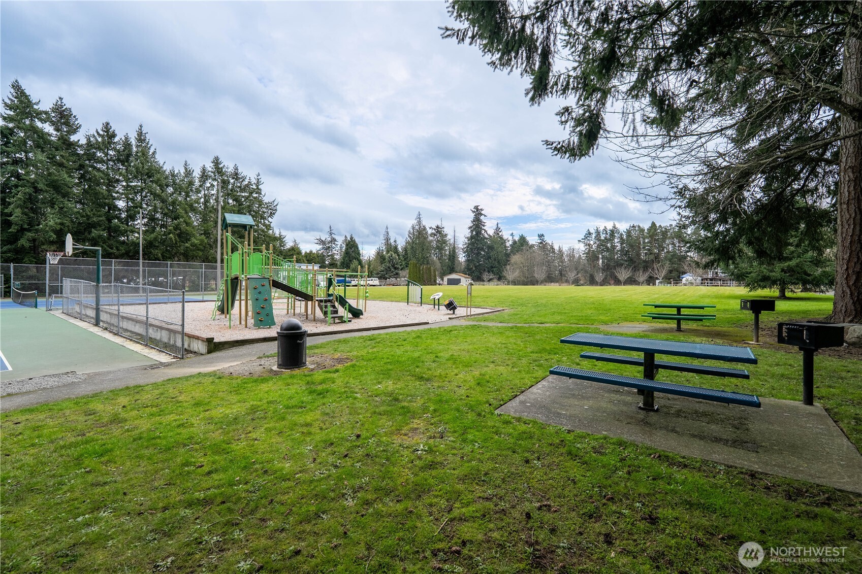 10794 Halloran Road Bow, WA 98232 - Photo 39 of 39 a park bench sitting in the middle of a park