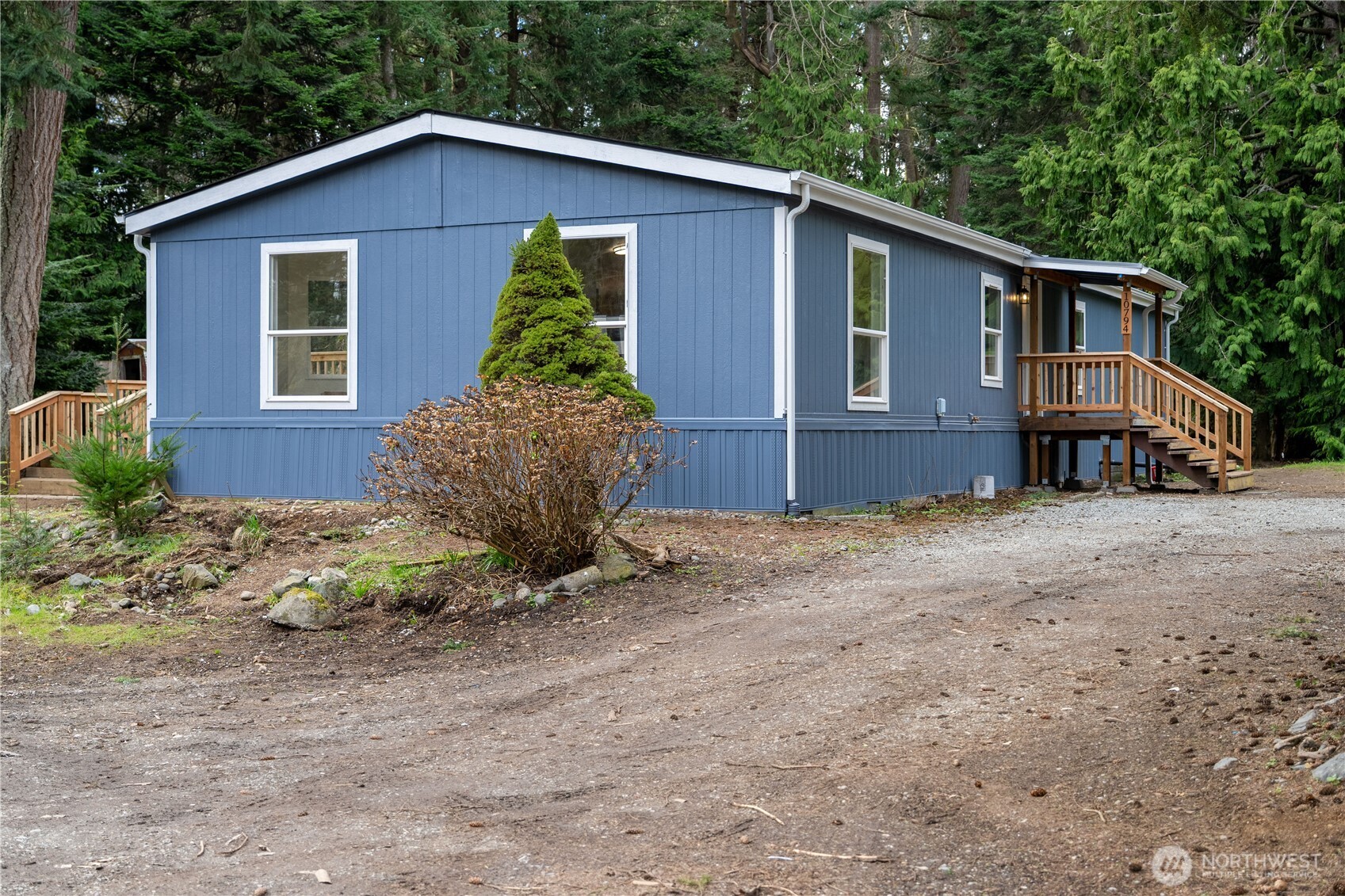 10794 Halloran Road Bow, WA 98232 - Photo 5 of 39 a view of a house with a yard plants and large tree