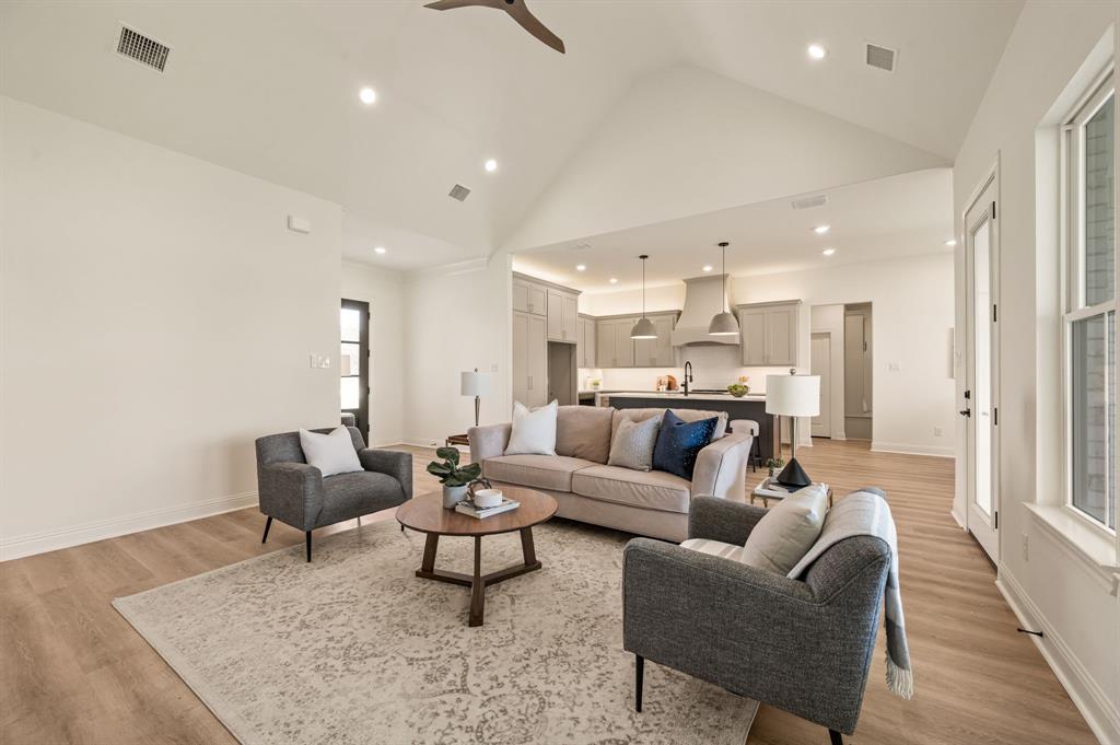 2705 Gospel Road Tolar, TX 76476 - Photo 10 of 36 Expansive living area featuring vaulted ceilings, recessed lighting, and luxury vinyl flooring