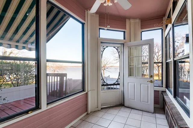 a view of a entryway door an empty room and a window