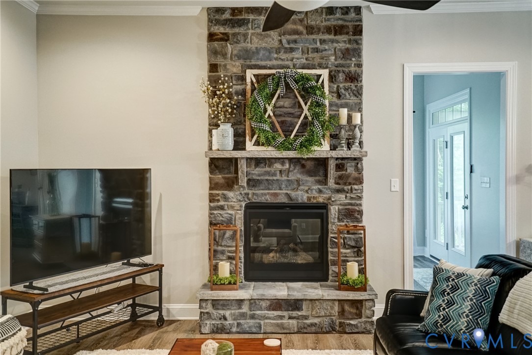 4669 Woburn Road Providence Forge, VA 23140 - Photo 19 of 78 a living room with a fireplace and a flat screen tv
