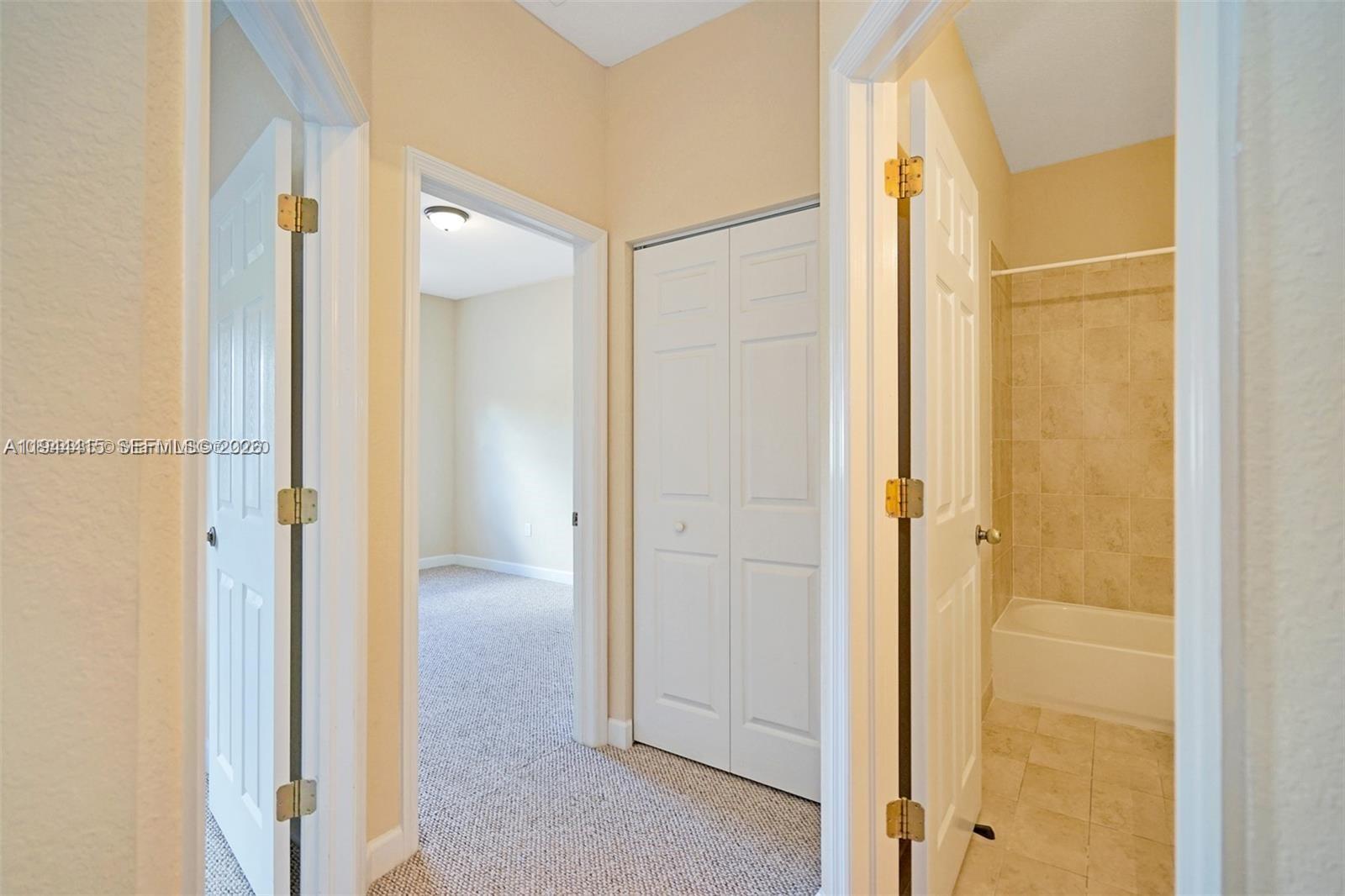 1048 Northeast 208th Street Miami, FL 33179 - Photo 23 of 36 a view of a bathroom with a glass door