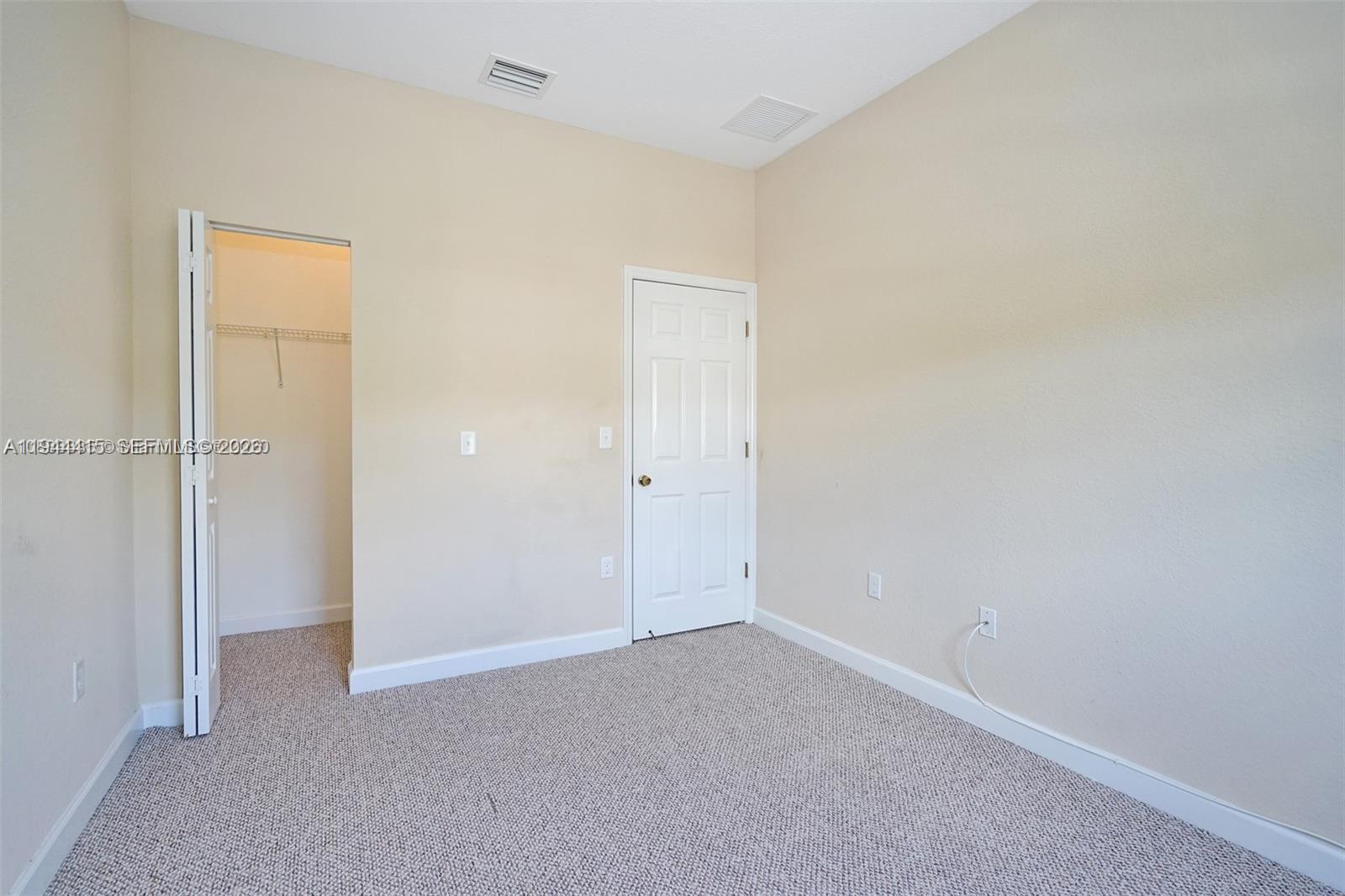 1048 Northeast 208th Street Miami, FL 33179 - Photo 26 of 36 an empty room with closet area