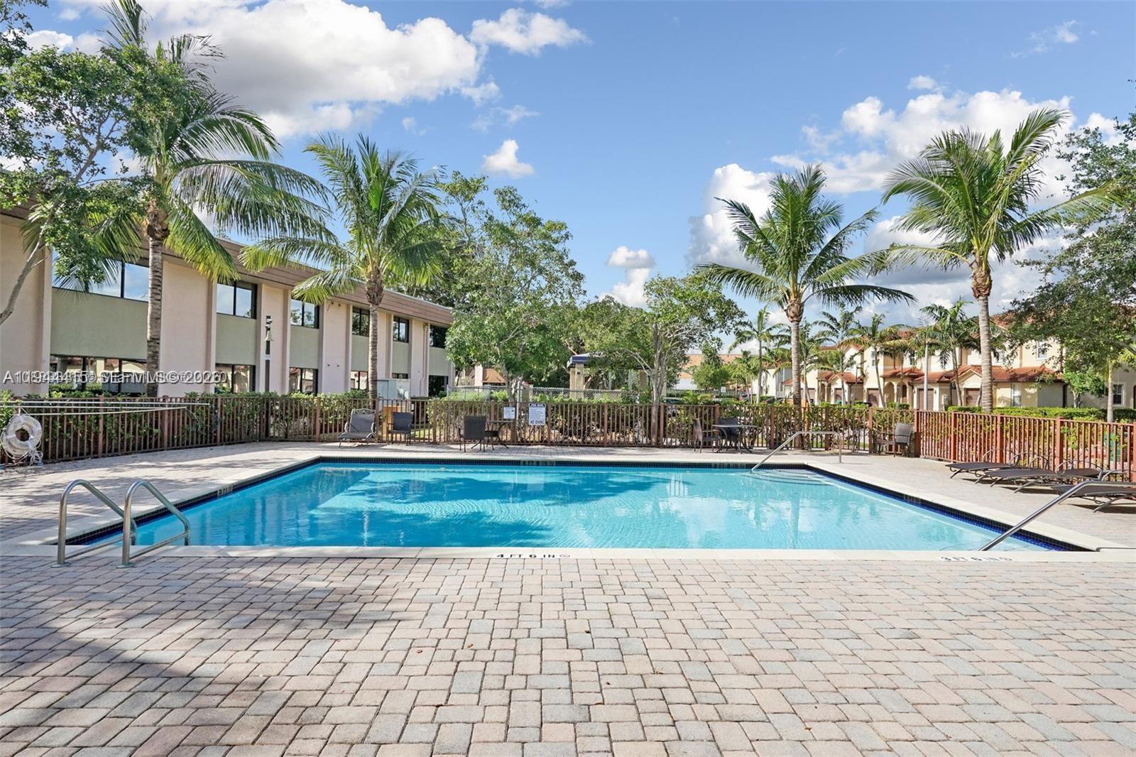 1048 Northeast 208th Street Miami, FL 33179 - Photo 34 of 36 a view of swimming pool with outdoor seating and plants