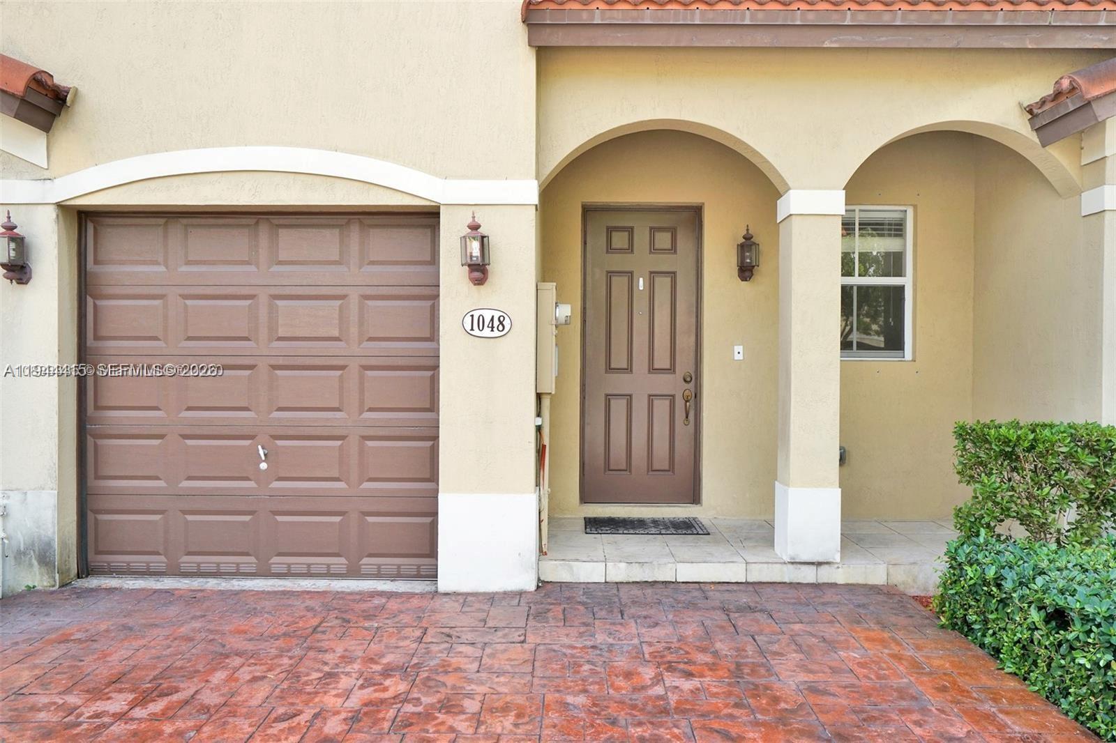 1048 Northeast 208th Street Miami, FL 33179 - Photo 4 of 36 a front view of a house