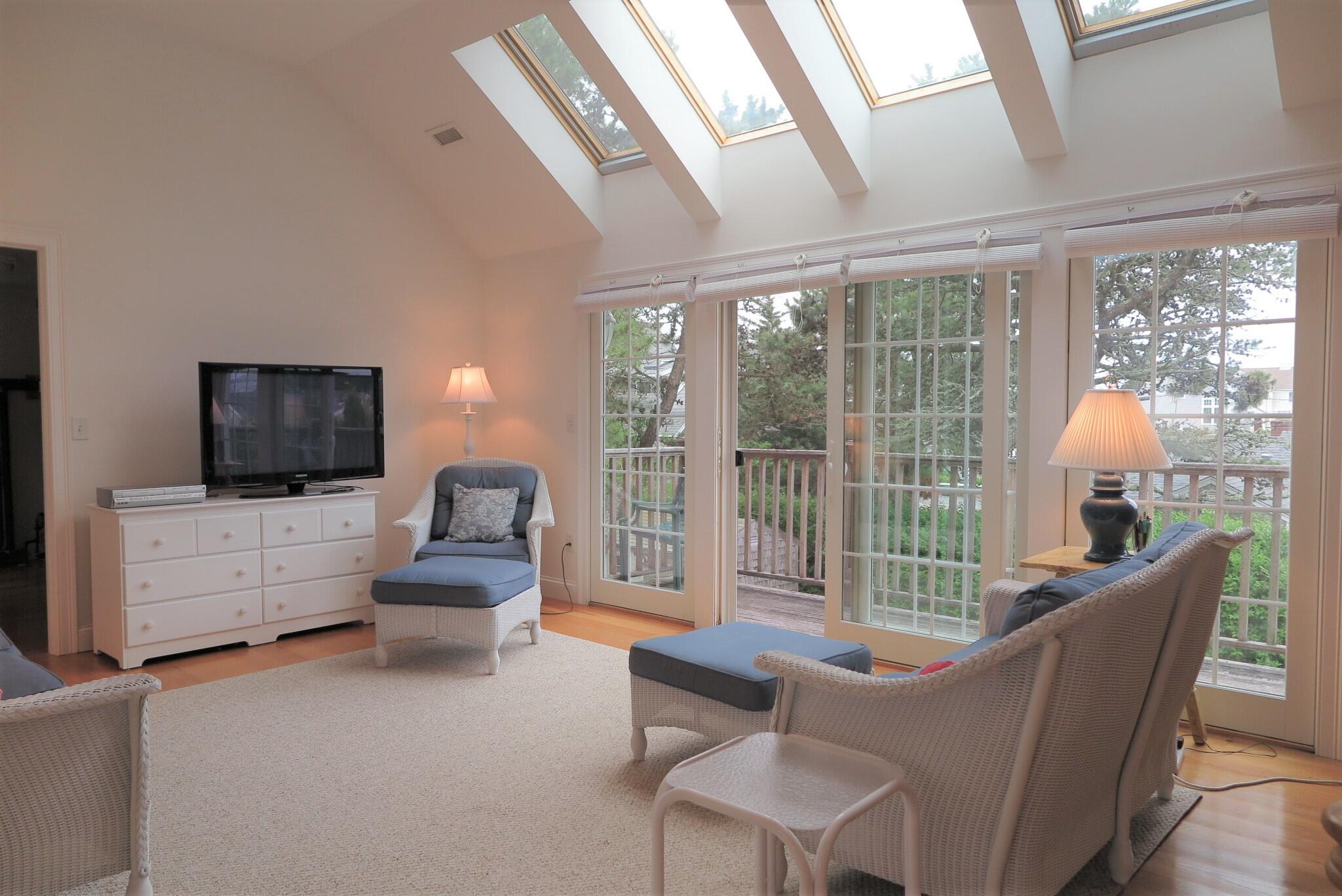 79 Shore Road West Dennis, MA 02670 - Photo 21 of 42 a living room with furniture and a flat screen tv