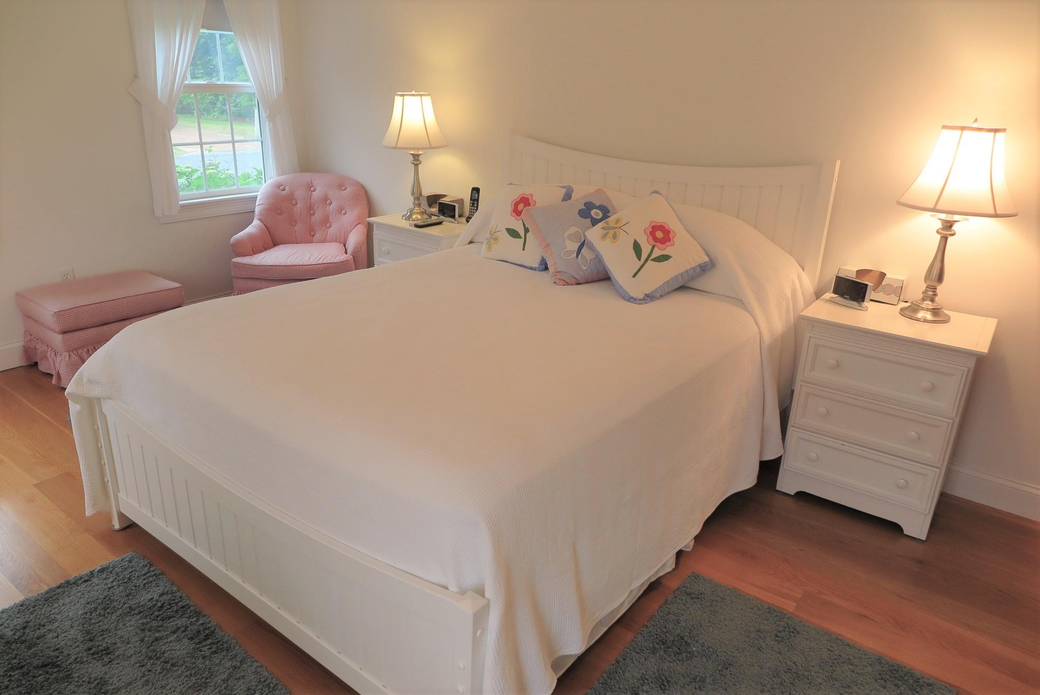 79 Shore Road West Dennis, MA 02670 - Photo 24 of 42 a bedroom with a bed and a night stand