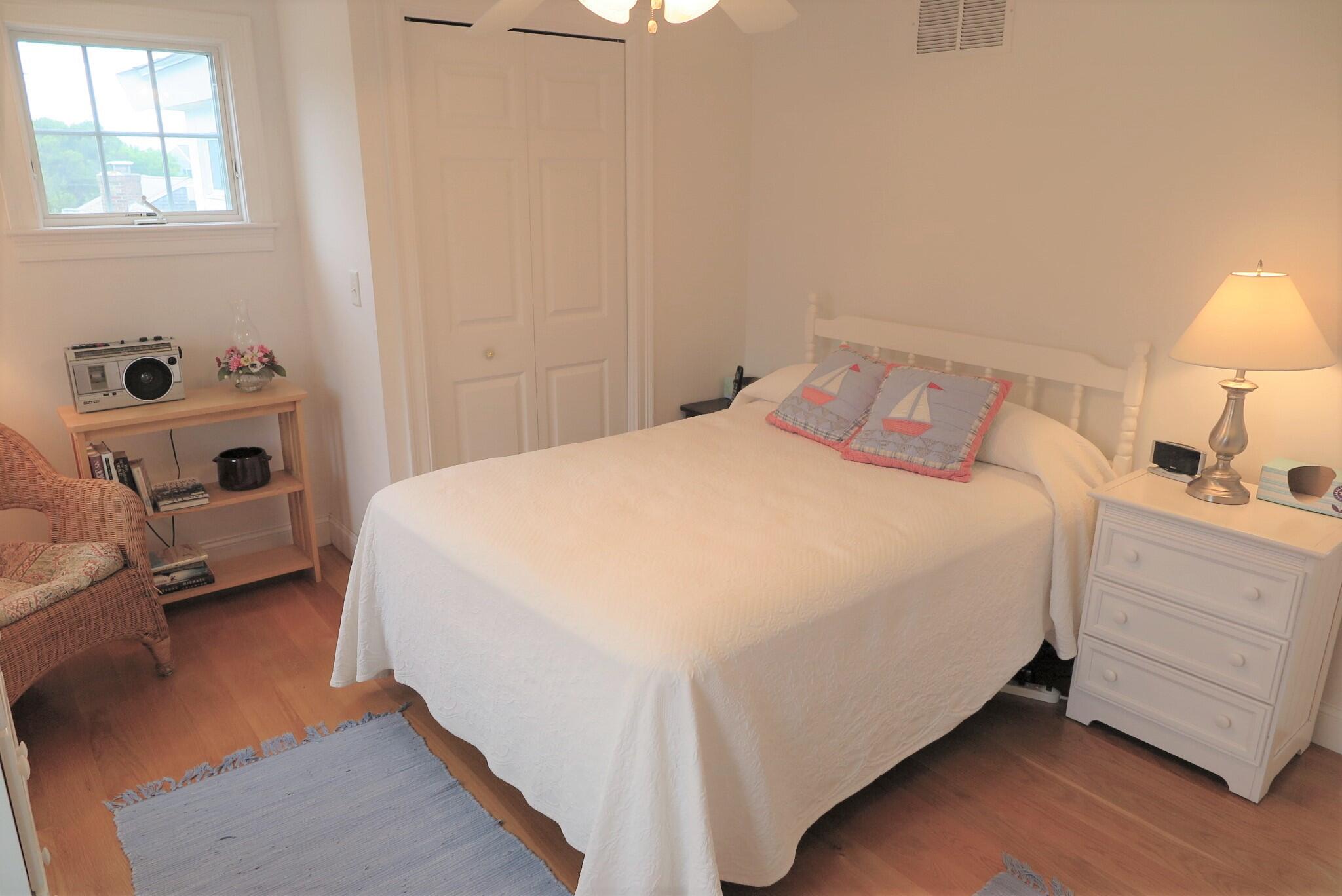 79 Shore Road West Dennis, MA 02670 - Photo 33 of 42 a bed room with a bed and a lamp