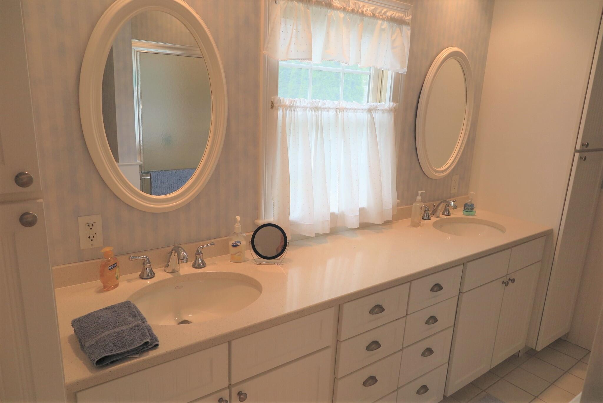 79 Shore Road West Dennis, MA 02670 - Photo 34 of 42 a bathroom with a double vanity sink and a mirror