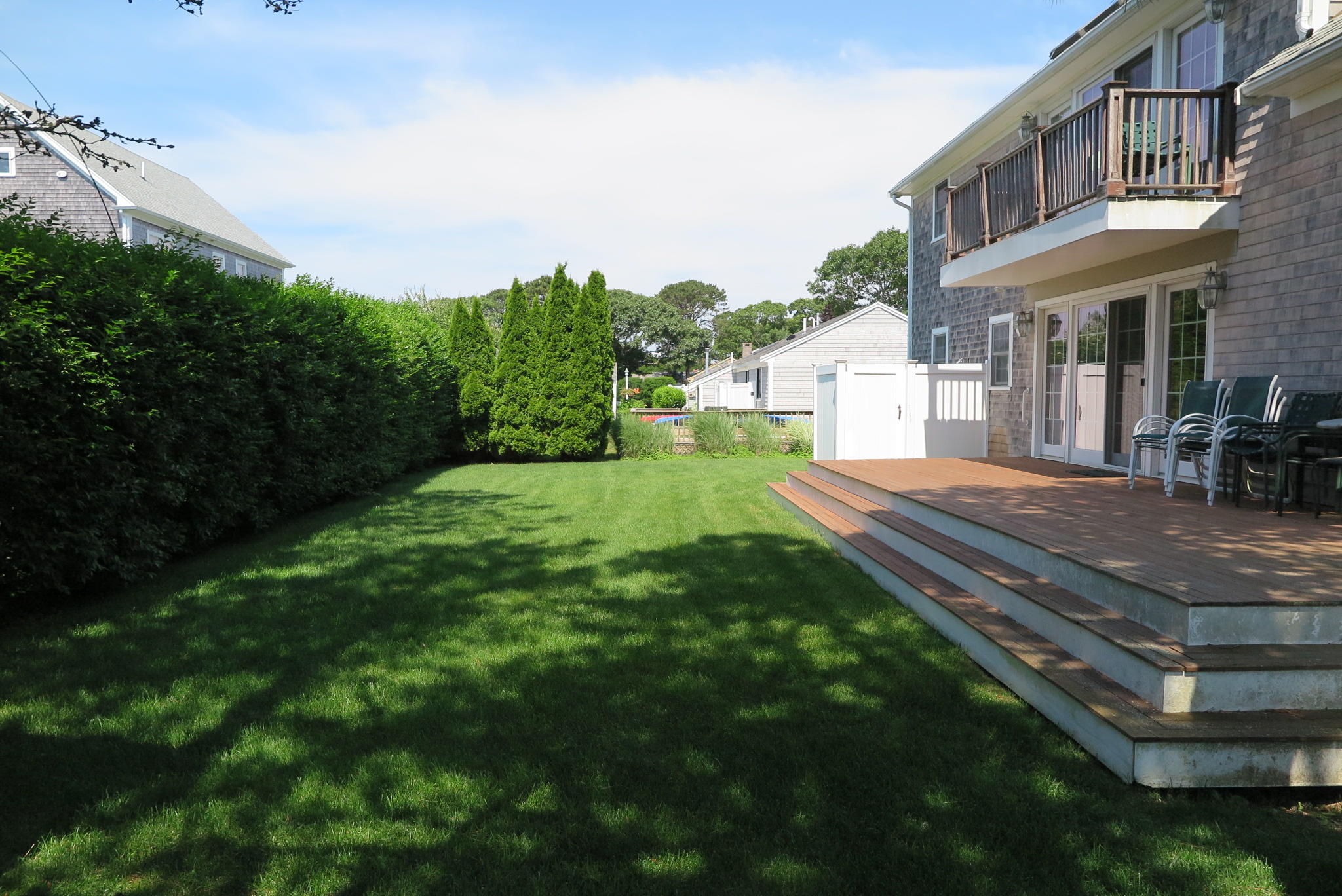 79 Shore Road West Dennis, MA 02670 - Photo 40 of 42 a front view of a house with a yard and trees