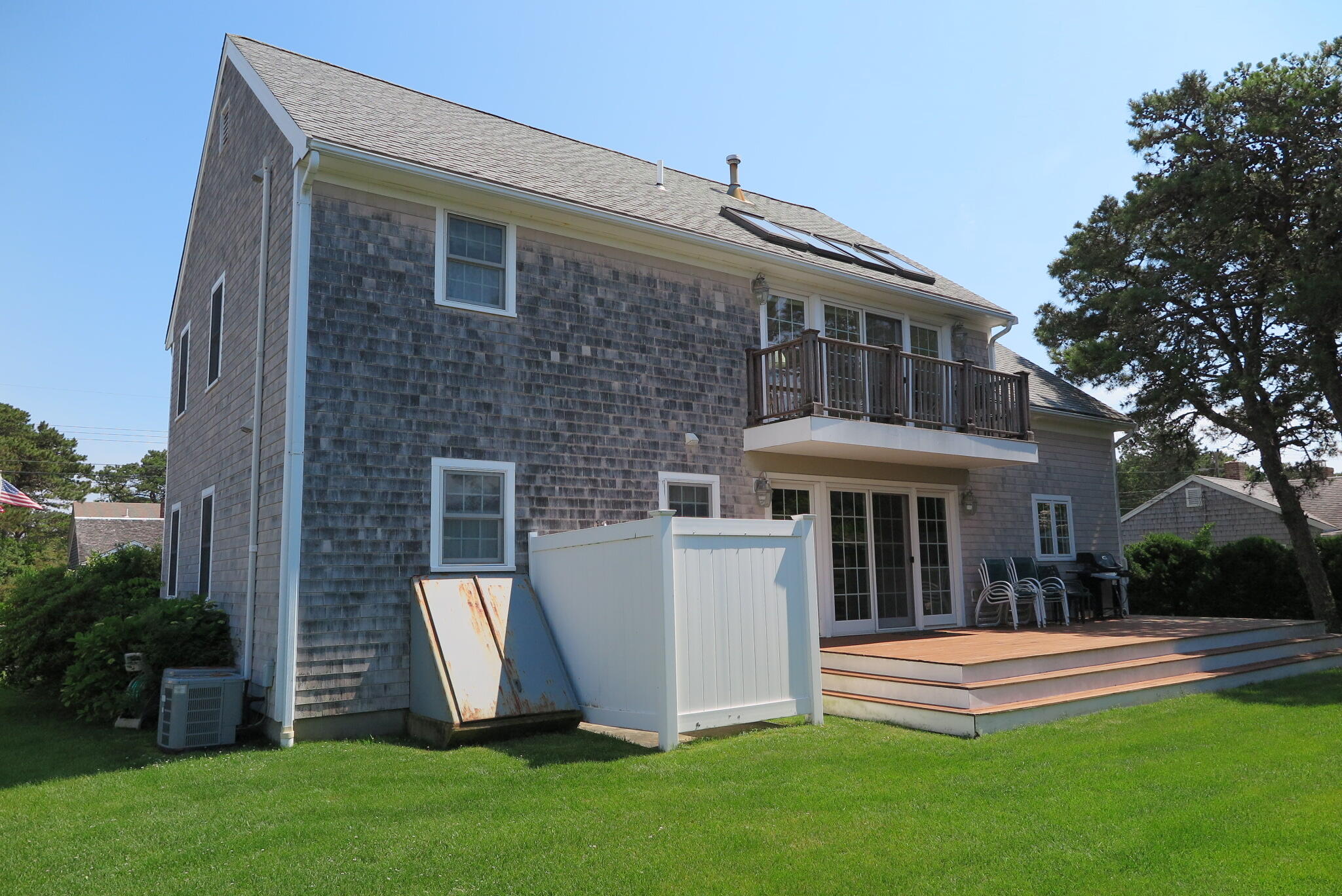 79 Shore Road West Dennis, MA 02670 - Photo 42 of 42 a front view of a house with a yard table and chairs