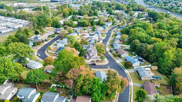an aerial view of residential houses with outdoor space