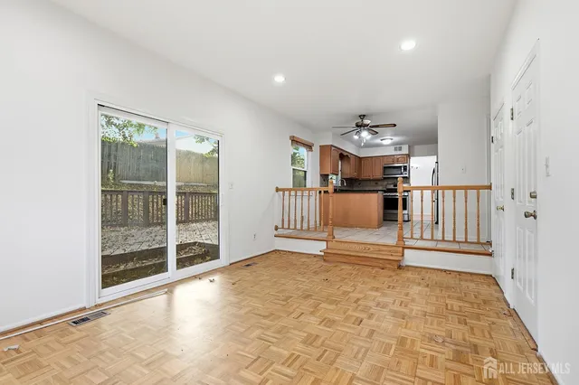 a view of a hallway with a dining table chairs and entryway