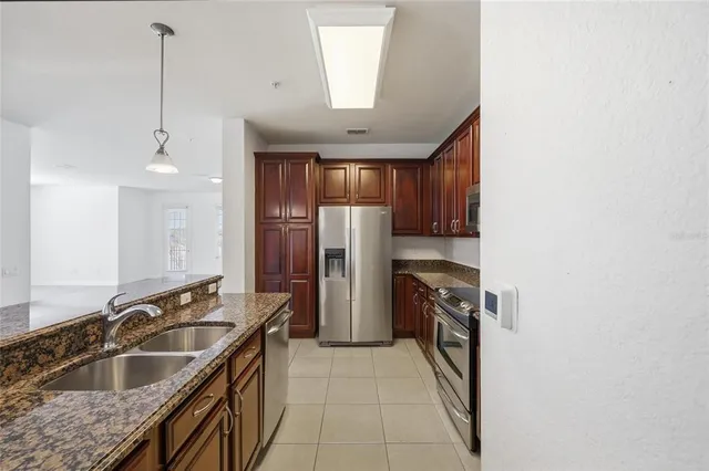a kitchen with a sink stove and refrigerator