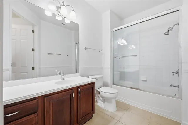 a bathroom with a double vanity sink toilet mirror and shower