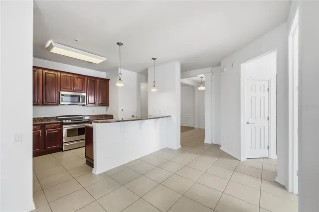 a large kitchen with cabinets and stainless steel appliances