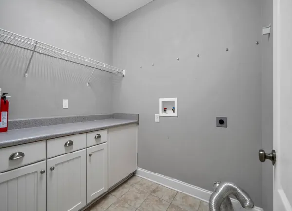 a view of a storage and utility room with racks on the wall