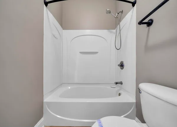 a white bath tub sitting next to a white toilet