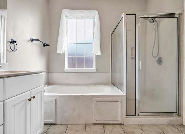 a bathroom with a bathtub and shower