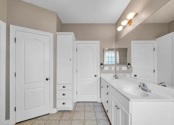 a spacious bathroom with a double vanity sink mirror and