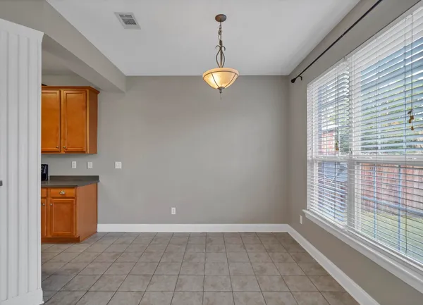 a view of a room with wooden floor and windows