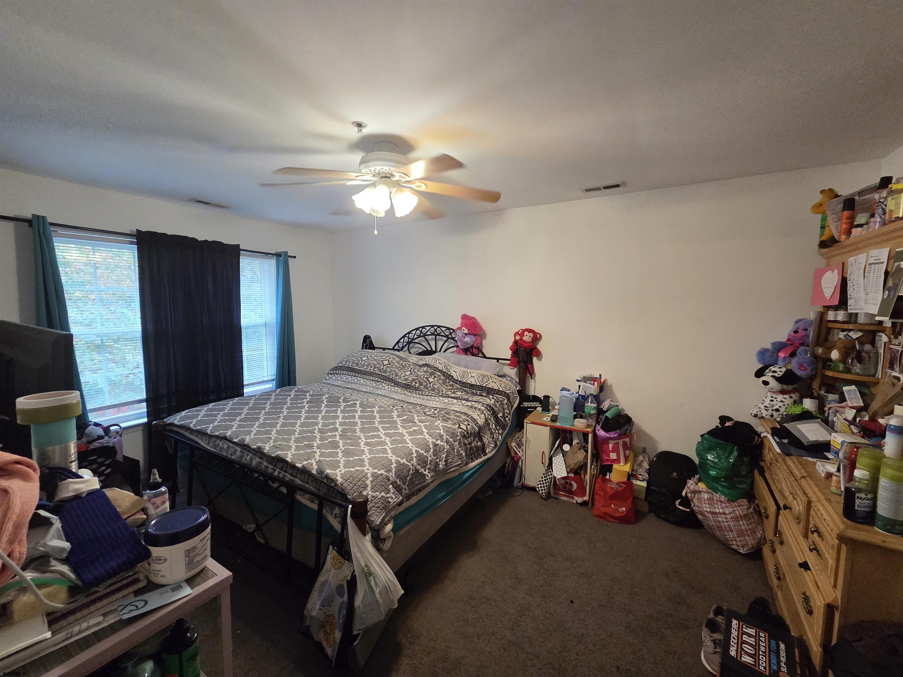 148 Natalie Road, Unit 148 Riverside, NJ 08075 - Photo 14 of 18 a bed room with a bed and a chandelier