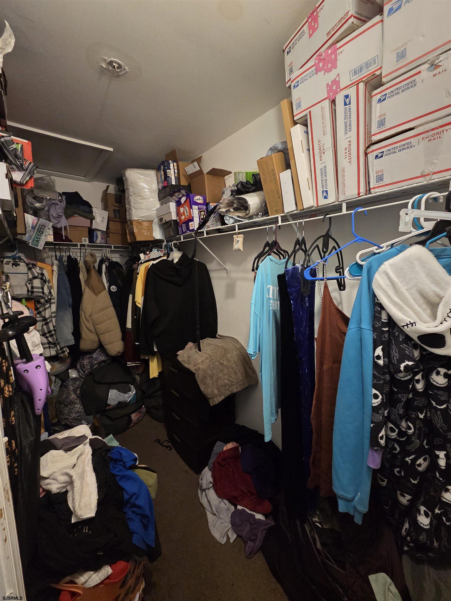 148 Natalie Road, Unit 148 Riverside, NJ 08075 - Photo 17 of 18 a view of walk in closet with clothes and shoes