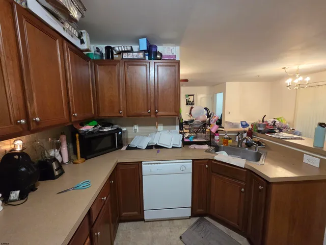 a kitchen with a sink cabinets and appliances