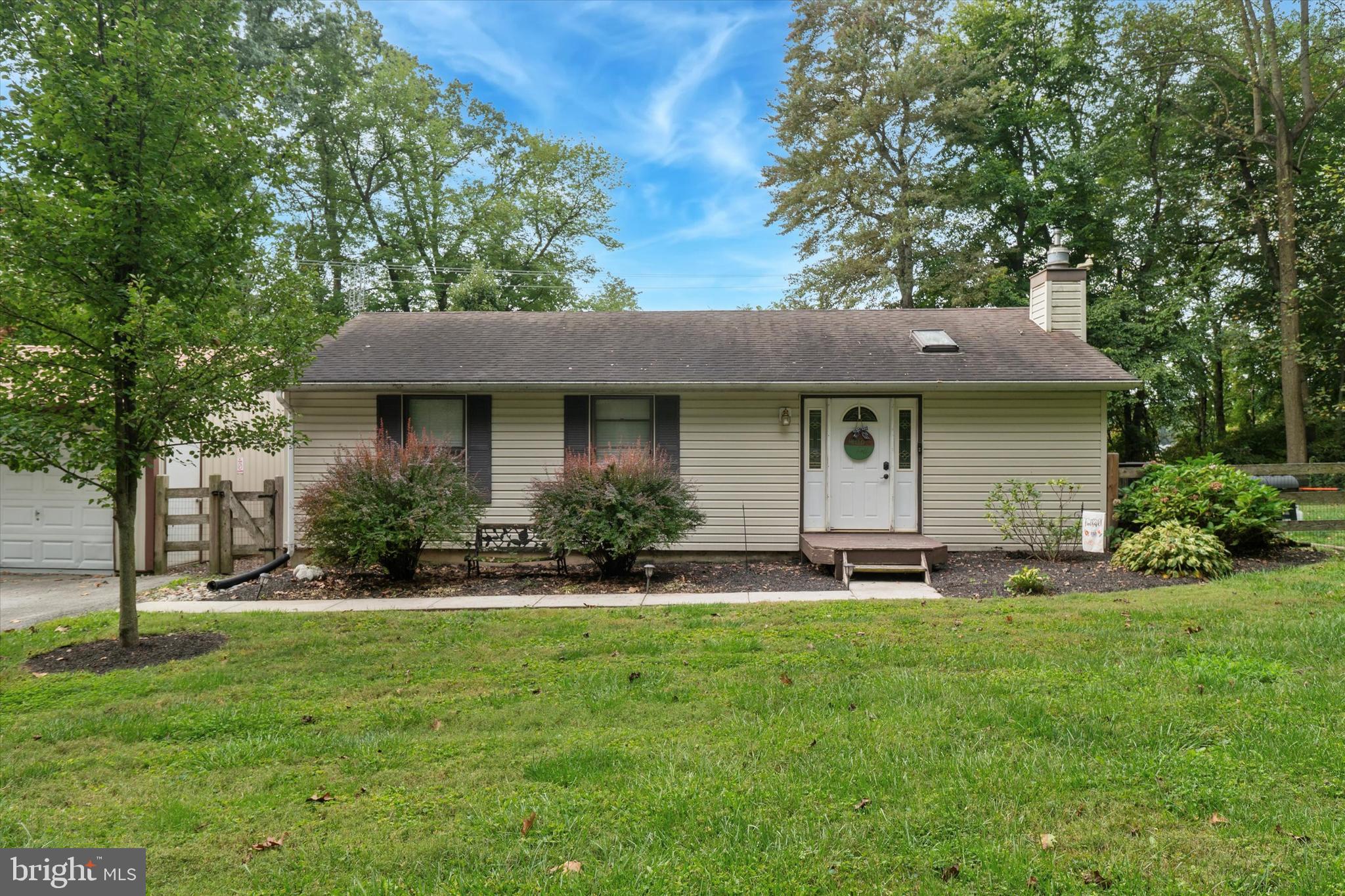 105 Cambridge Road Coatesville, PA 19320 - Photo 1 of 21 a front view of a house with a garden and trees
