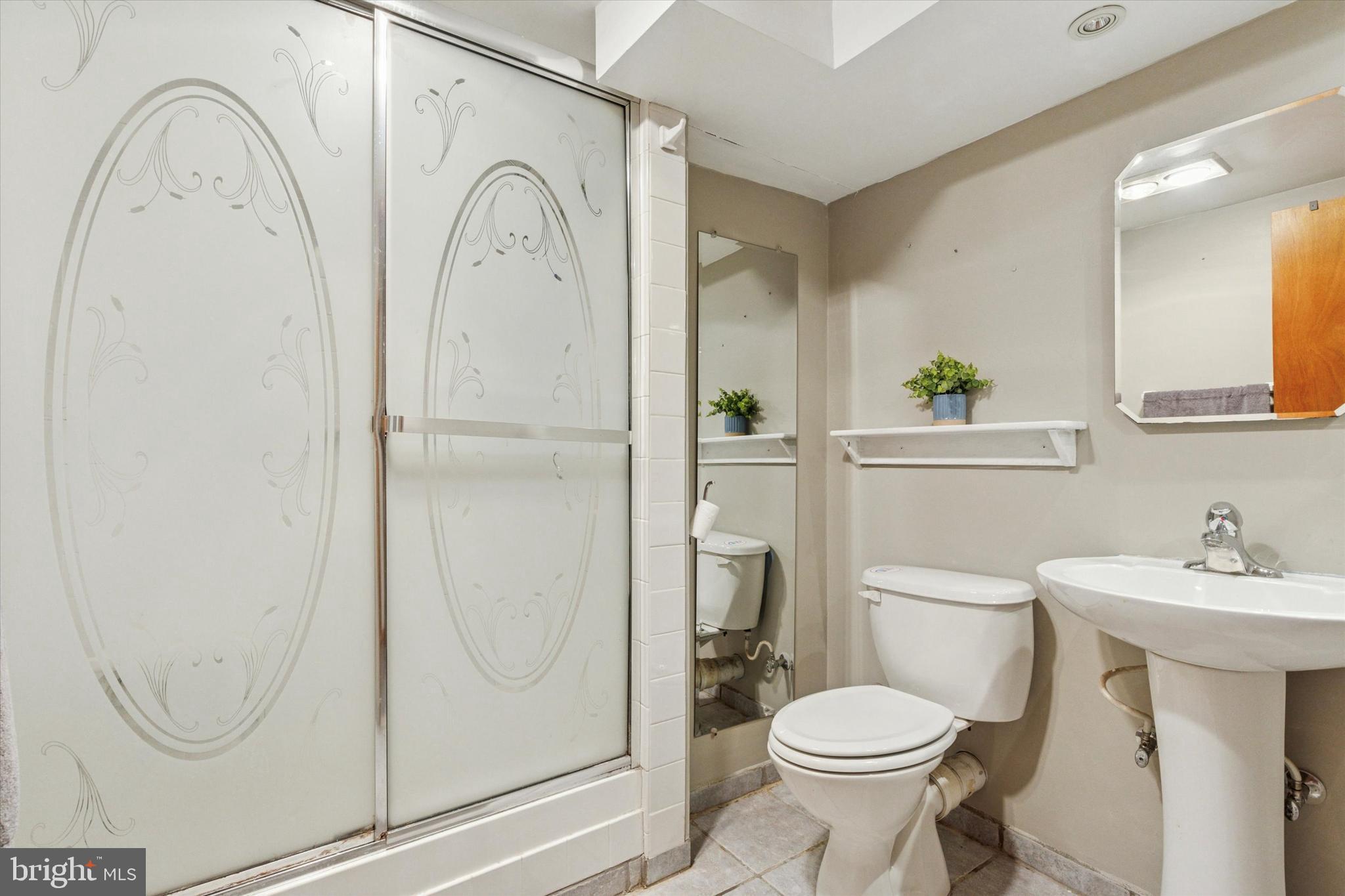 105 Cambridge Road Coatesville, PA 19320 - Photo 14 of 21 a white toilet sitting next to a bathroom sink
