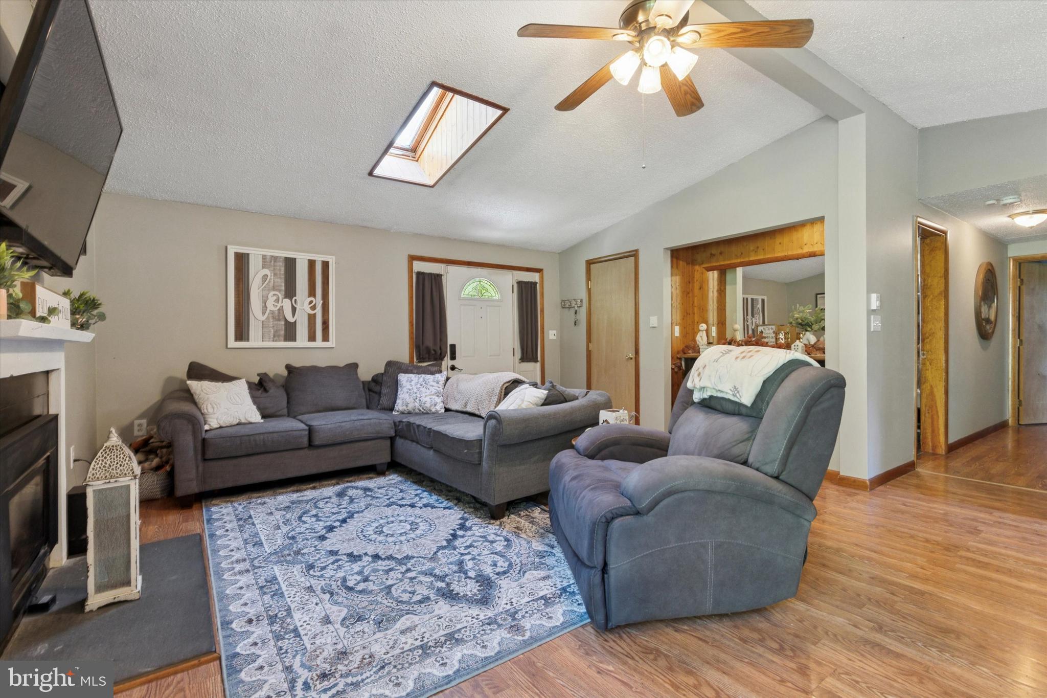 105 Cambridge Road Coatesville, PA 19320 - Photo 6 of 21 a living room with furniture a ceiling fan and a rug