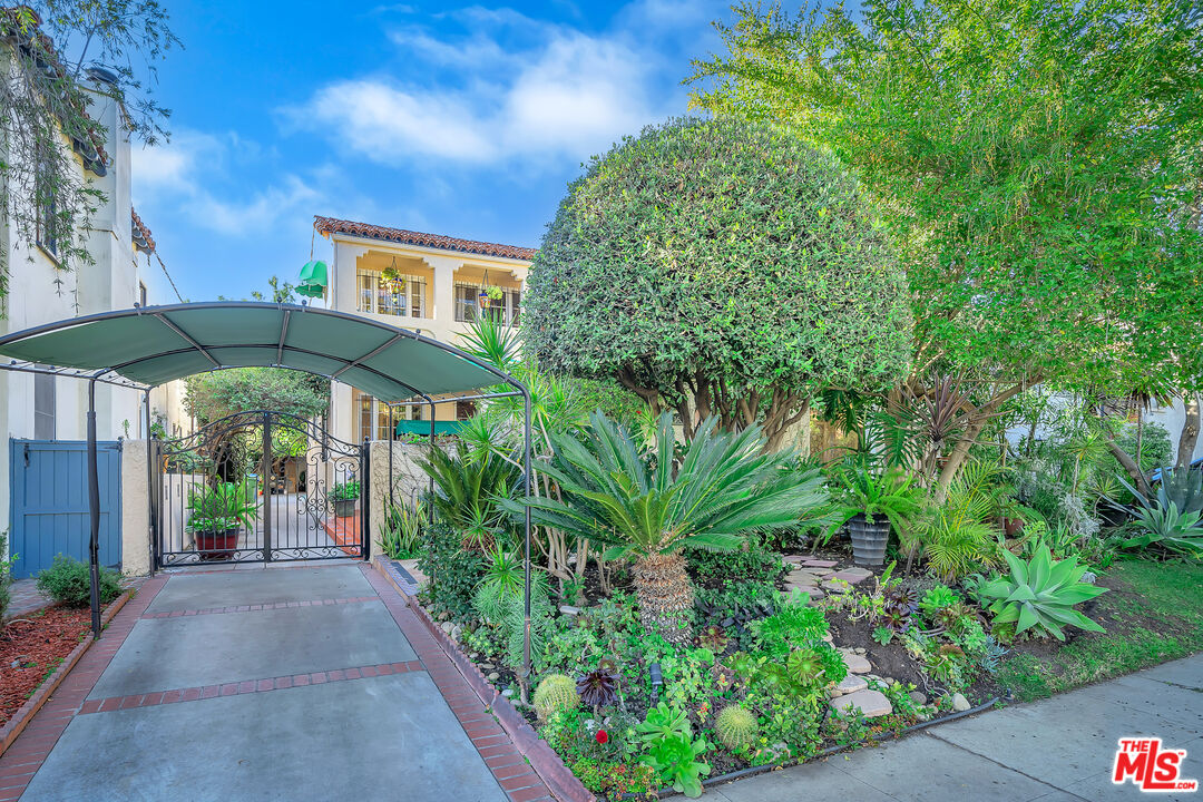 1163 Hi Point Street Los Angeles, CA 90035 - Photo 1 of 29 a view of patio with a table and chairs under an umbrella