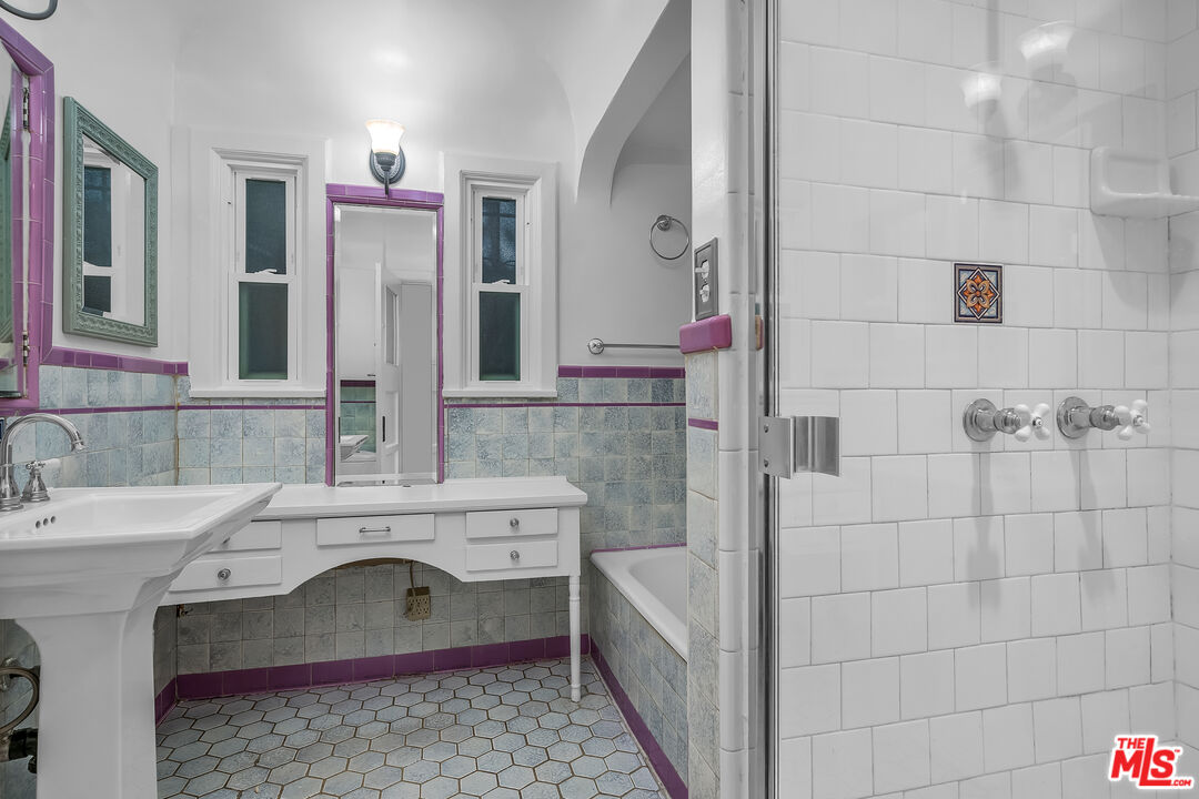 1163 Hi Point Street Los Angeles, CA 90035 - Photo 11 of 29 a bathroom with a sink and a mirror