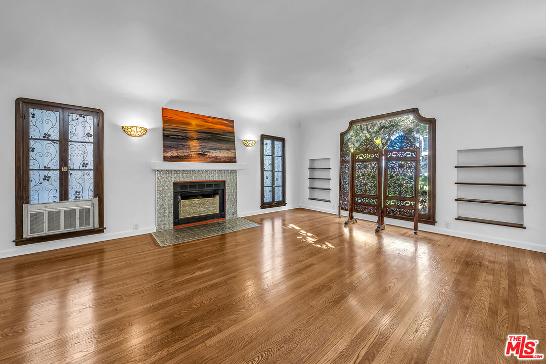 1163 Hi Point Street Los Angeles, CA 90035 - Photo 15 of 29 a view of an empty room with wooden floor and a window