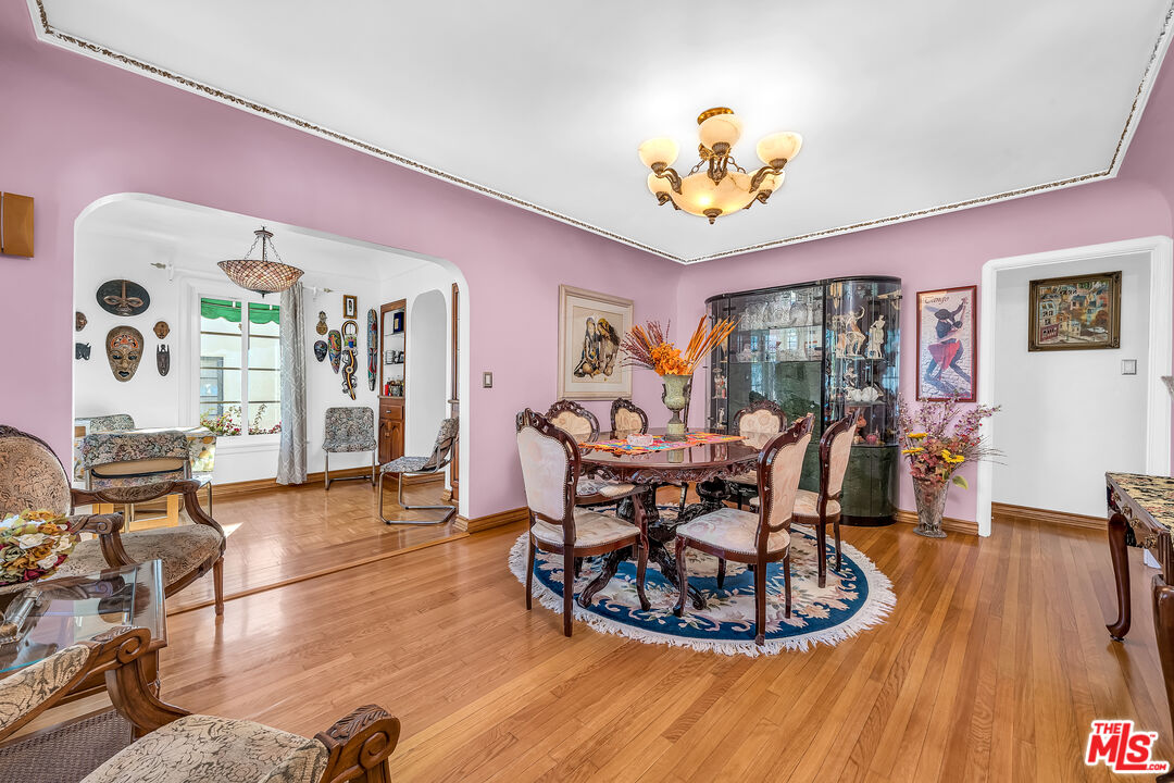 1163 Hi Point Street Los Angeles, CA 90035 - Photo 6 of 29 a living room with furniture a dining table and a potted plant