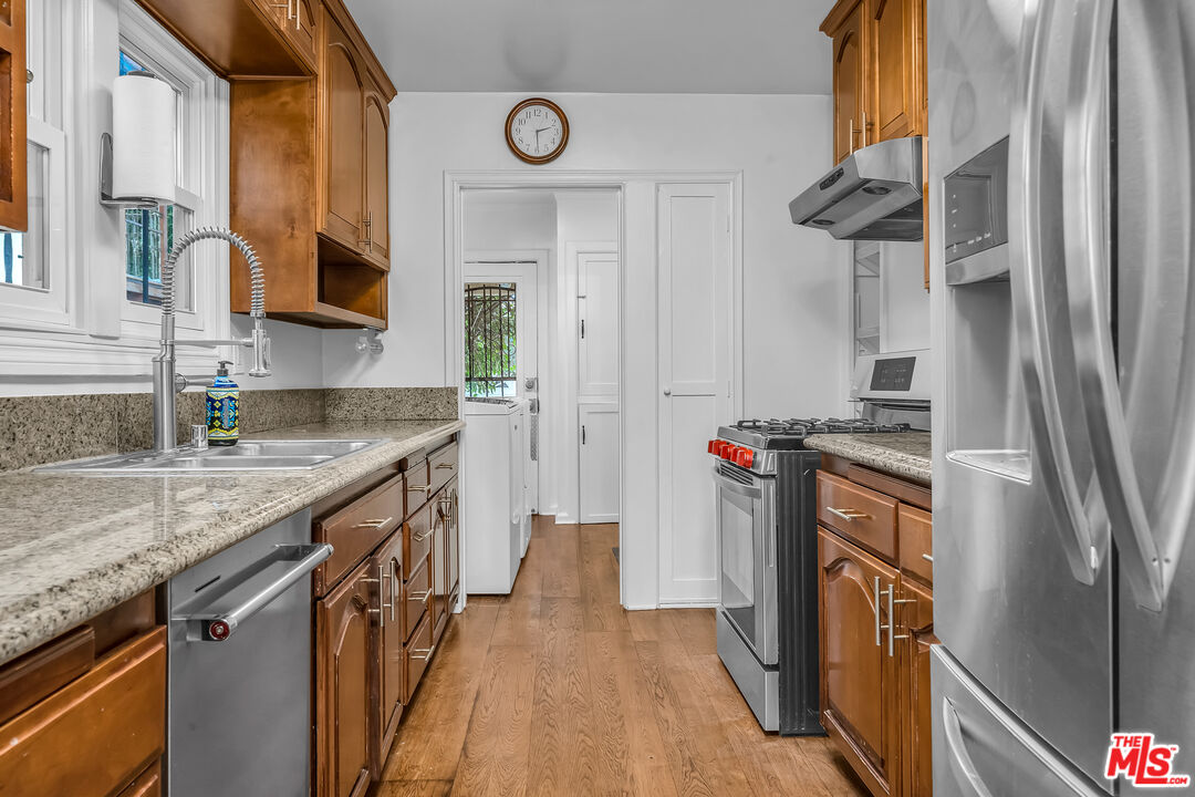 1163 Hi Point Street Los Angeles, CA 90035 - Photo 10 of 29 a kitchen with stainless steel appliances granite countertop a refrigerator and a sink