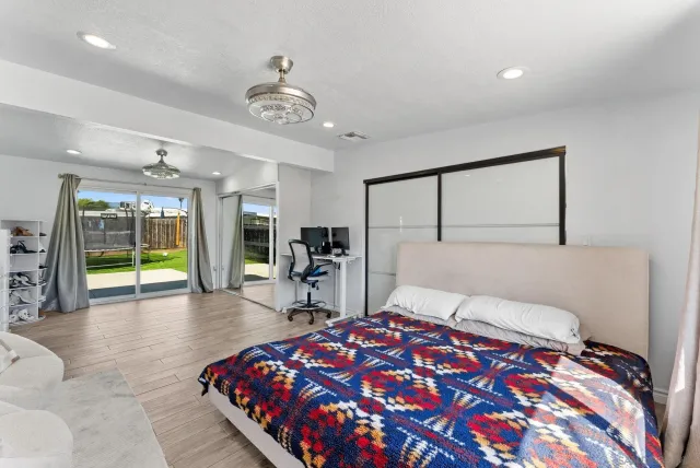 a bedroom with a large bed and a chandelier