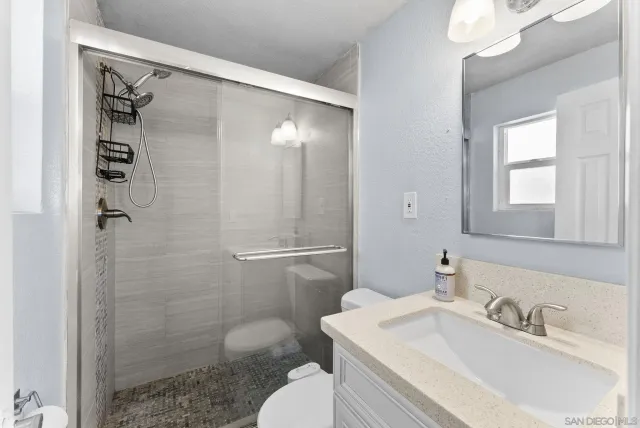 a bathroom with a sink toilet and shower