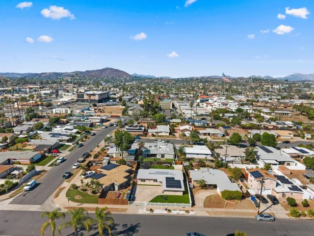 an aerial view of residential houses with city view