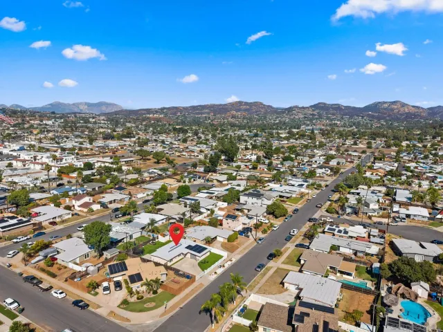 an aerial view of residential houses with city view