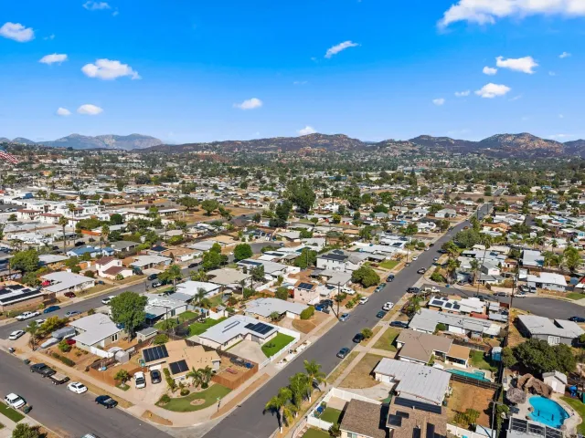 an aerial view of residential houses with city view