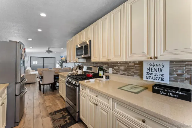 a kitchen with a sink a stove and cabinets