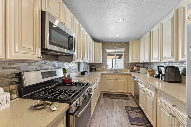 a kitchen with a stove a sink and a microwave