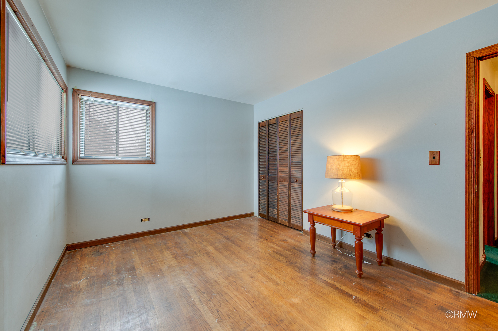 305 East Normandy Drive Addison, IL 60101 - Photo 11 of 24 a view of a room with wooden floor a glass door and chair
