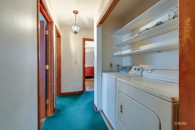 a view of storage and utility room with washer and dryer