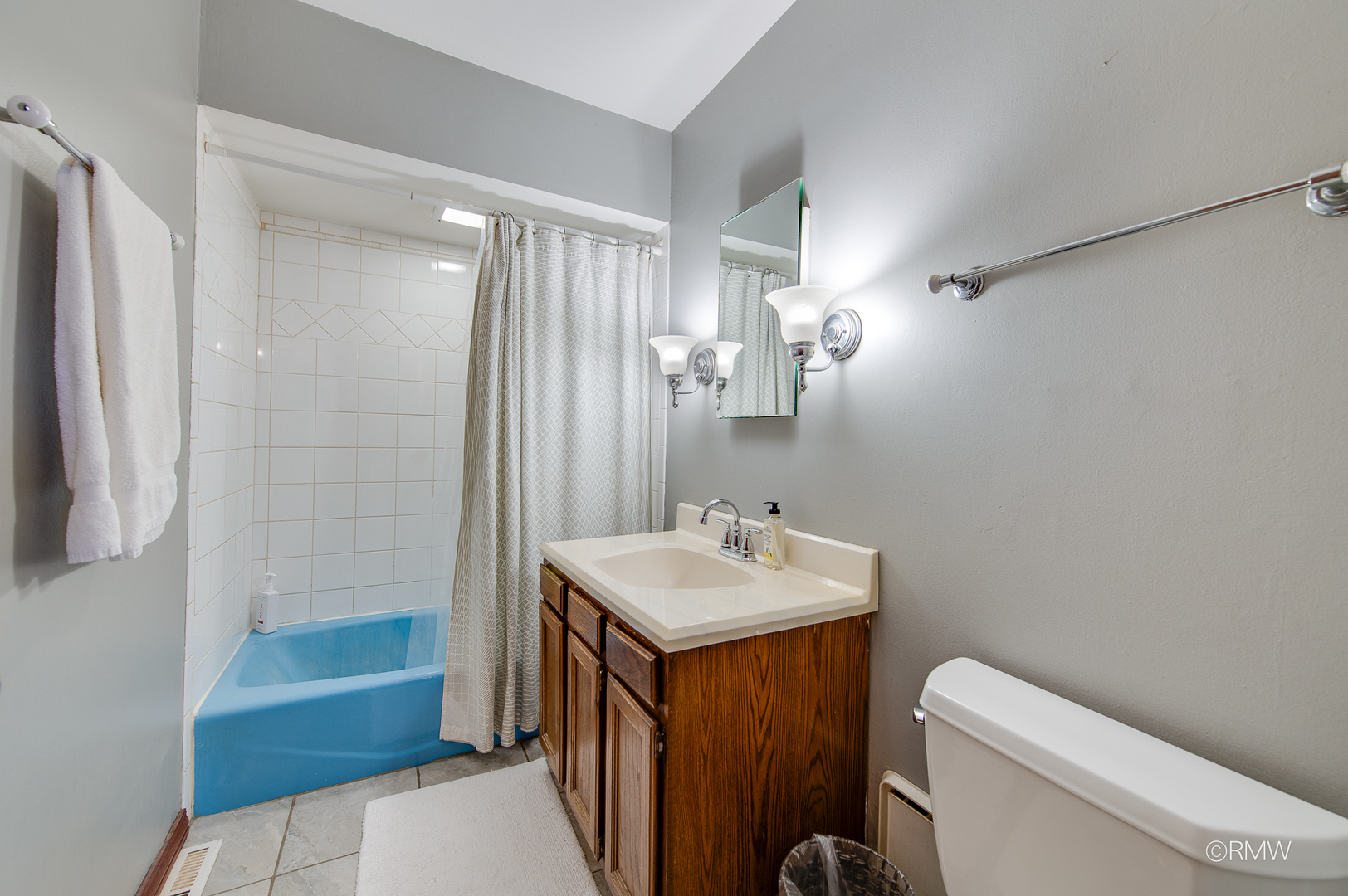 305 East Normandy Drive Addison, IL 60101 - Photo 13 of 24 a bathroom with a sink a toilet a mirror and shower
