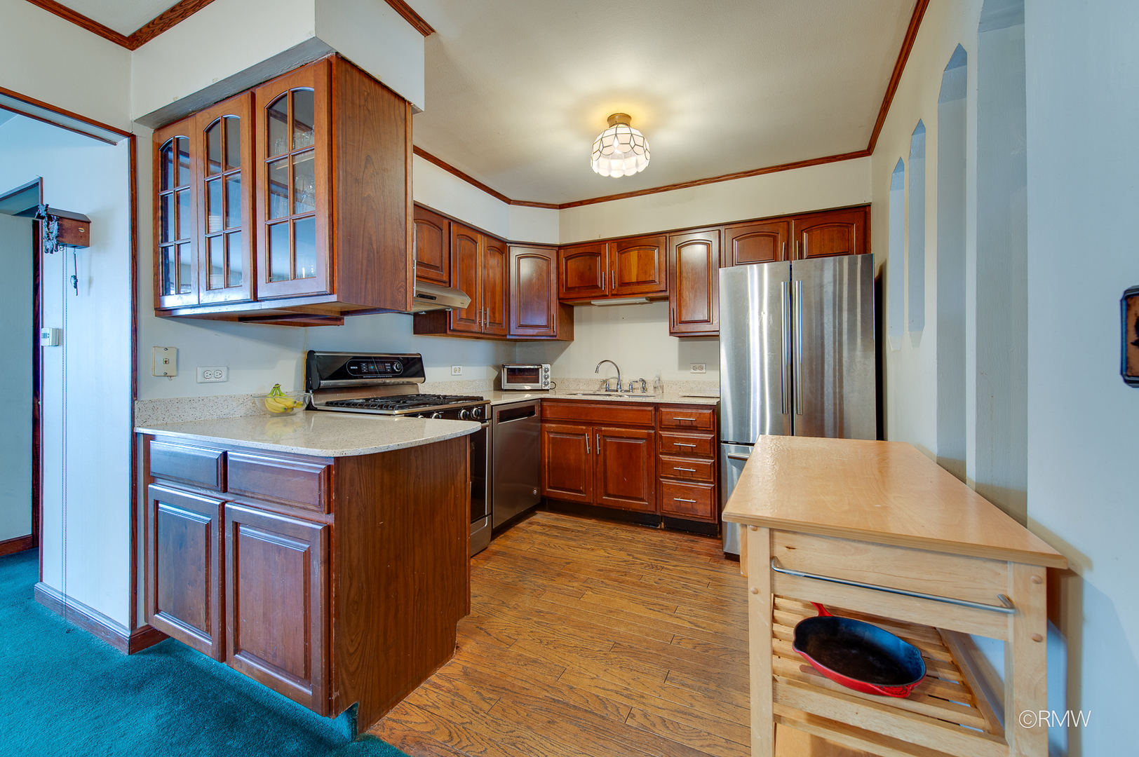 305 East Normandy Drive Addison, IL 60101 - Photo 8 of 24 a kitchen with a refrigerator and a sink