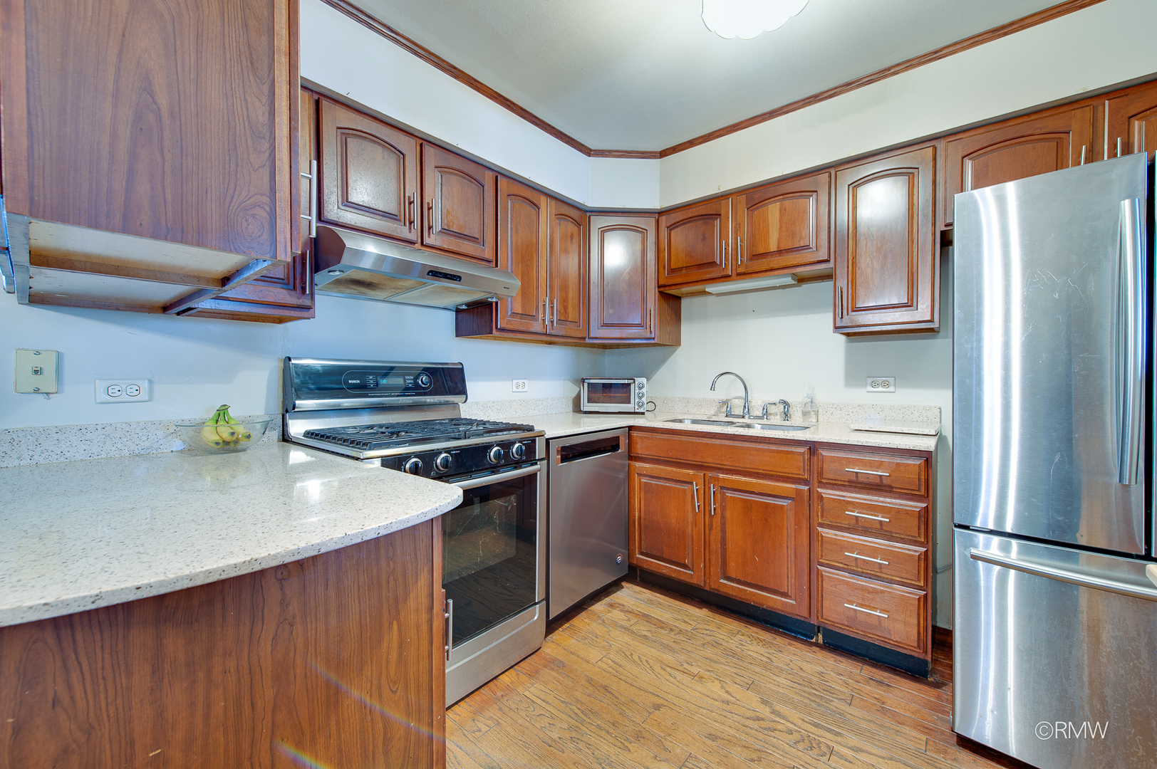 305 East Normandy Drive Addison, IL 60101 - Photo 9 of 24 a kitchen with stainless steel appliances granite countertop wooden cabinets a stove a sink and a refrigerator
