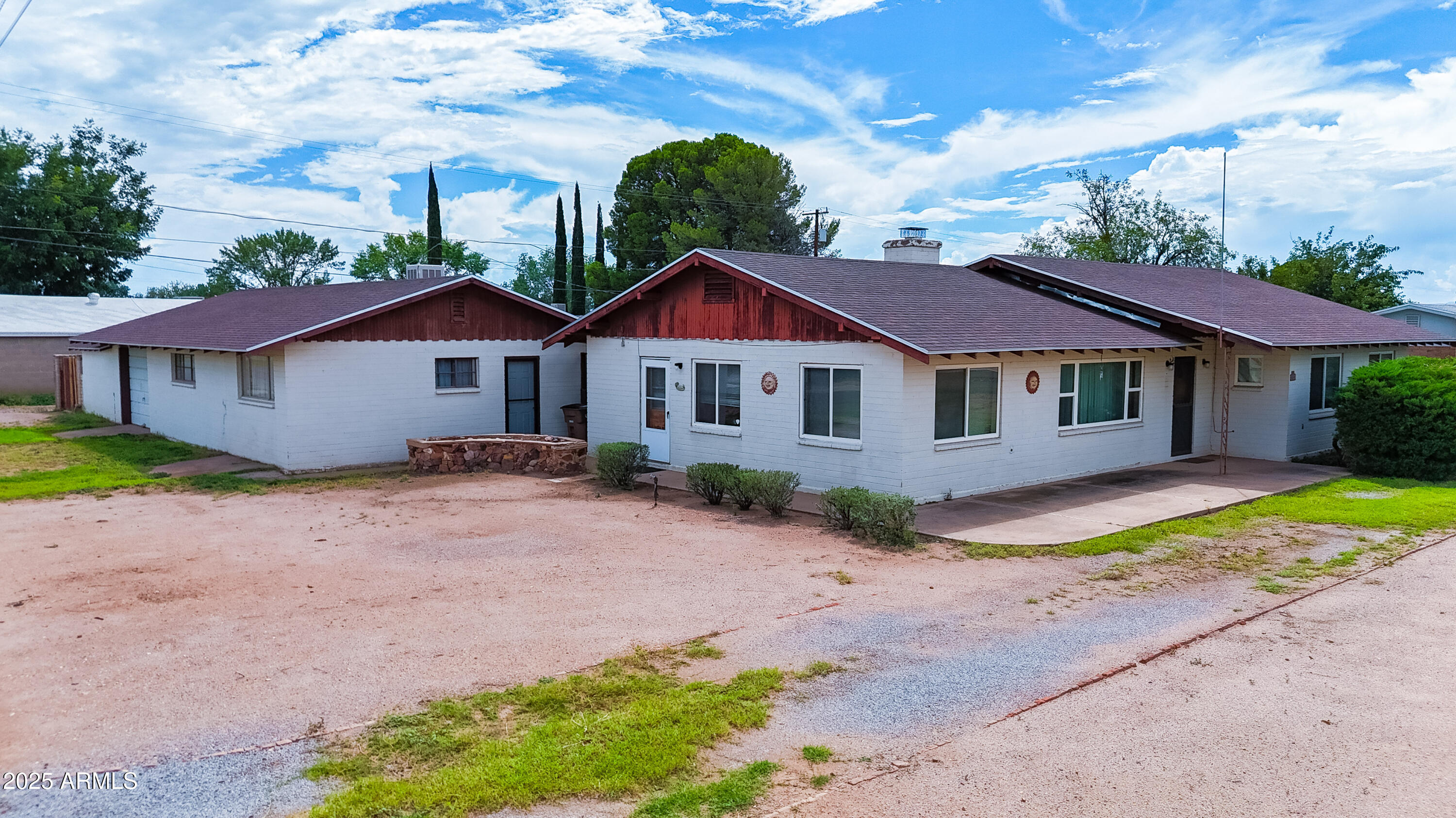 a view of a house with a yard and potted plants