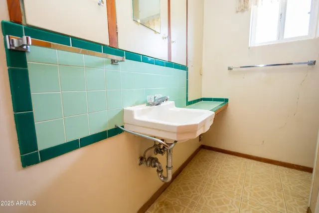 a bathroom with a sink and mirror